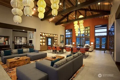 a living room with furniture a chandelier and a fireplace