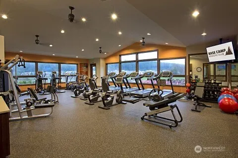 a view of a room with gym equipment and a large window
