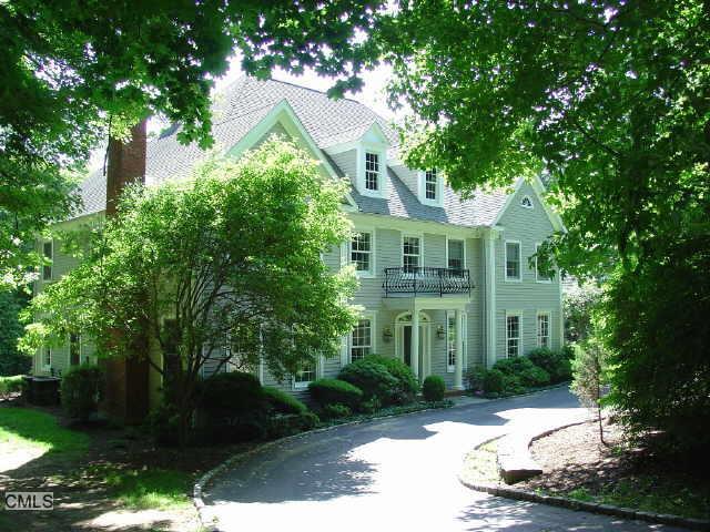 67 East Meadow Road Wilton, CT 06897 - Photo 1 of 1 a front view of a house with a yard and trees