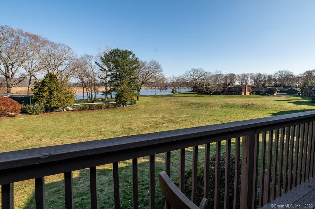 85 River Road, Unit C6 Essex, CT 06426 - Photo 1 of 34 a view of a swimming pool with a lawn chairs and a large tree