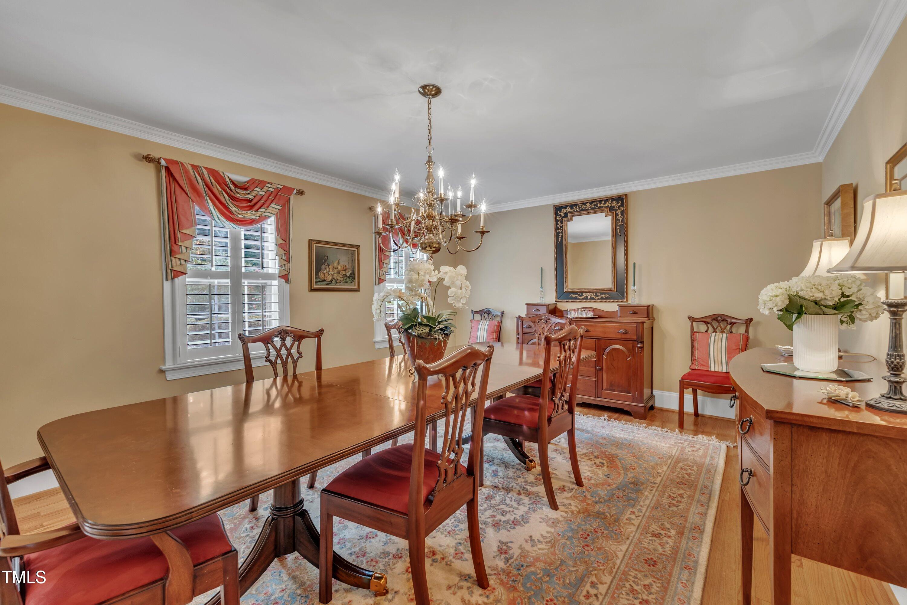 2013 Eagleton Circle Raleigh, NC 27609 - Photo 11 of 62 a dining room with furniture a chandelier and wooden floor
