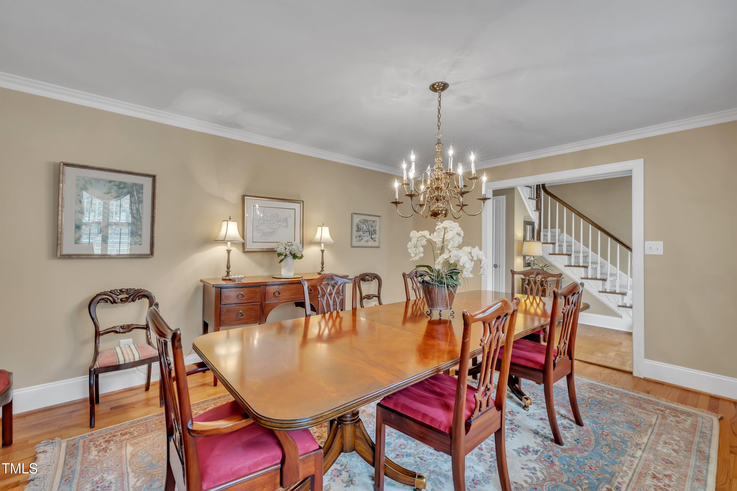 2013 Eagleton Circle Raleigh, NC 27609 - Photo 12 of 62 a dining room with furniture a chandelier and wooden floor