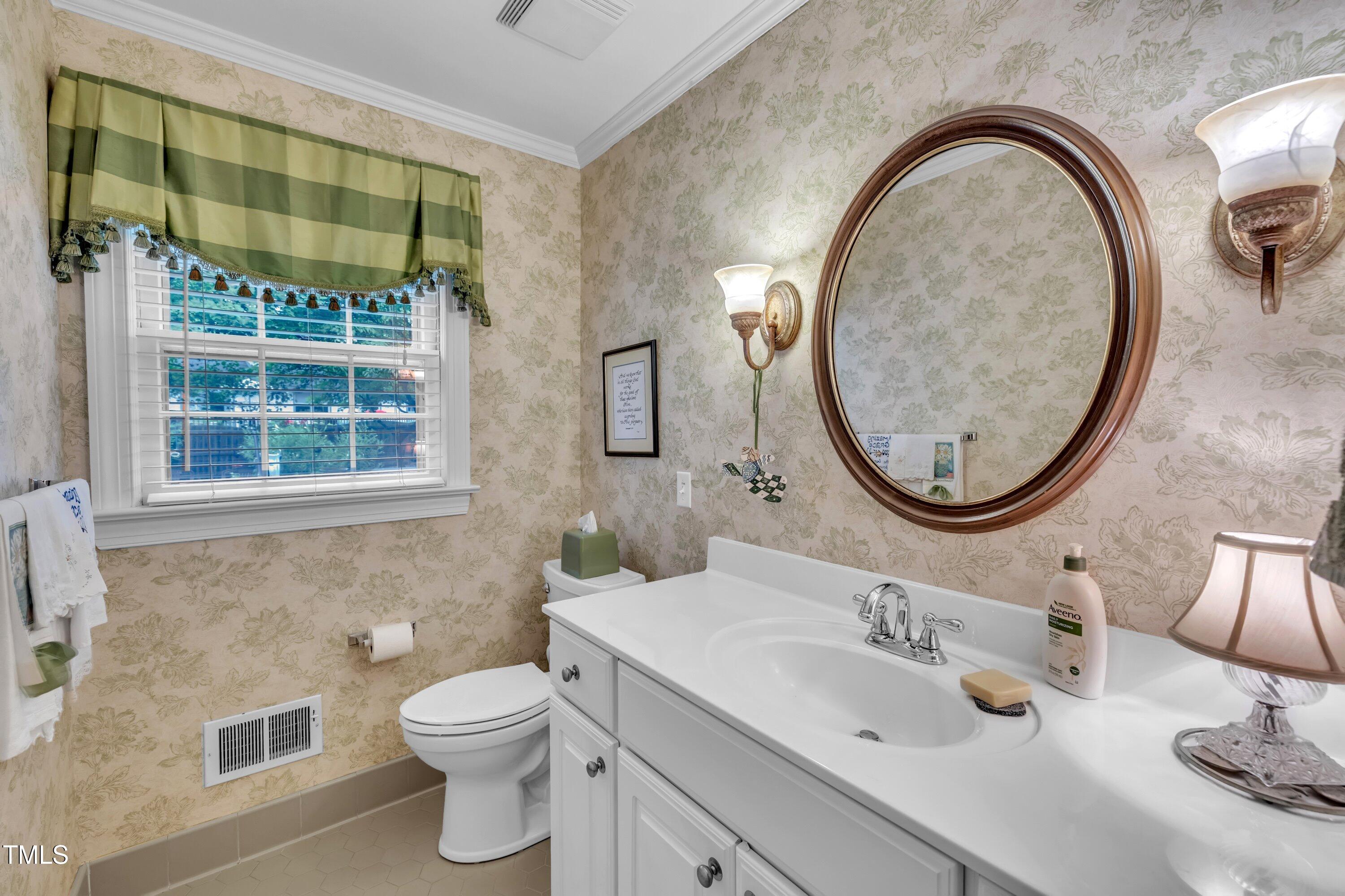 2013 Eagleton Circle Raleigh, NC 27609 - Photo 18 of 62 a bathroom with a sink a toilet and a mirror