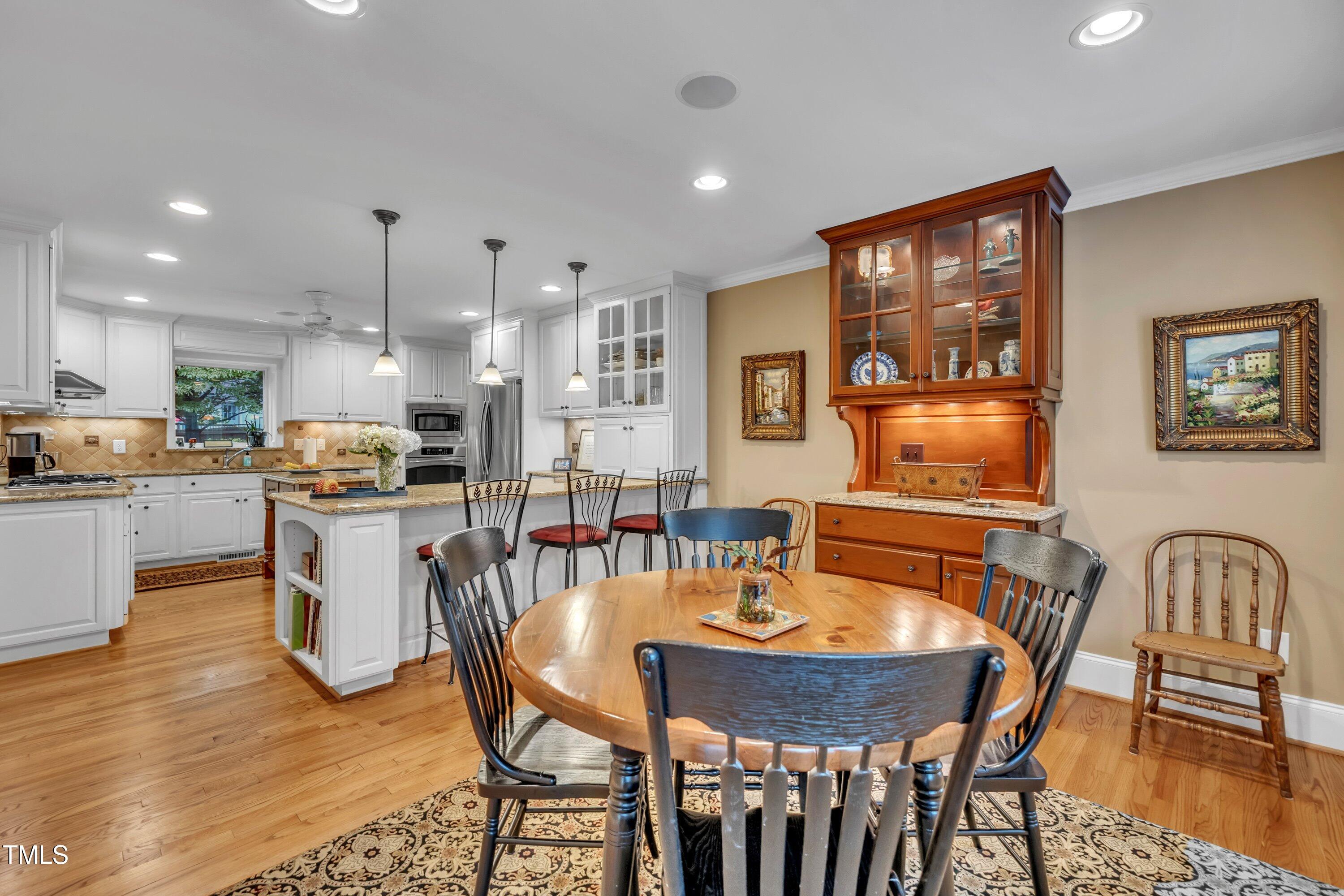 2013 Eagleton Circle Raleigh, NC 27609 - Photo 20 of 62 a dining room with stainless steel appliances a table and chairs