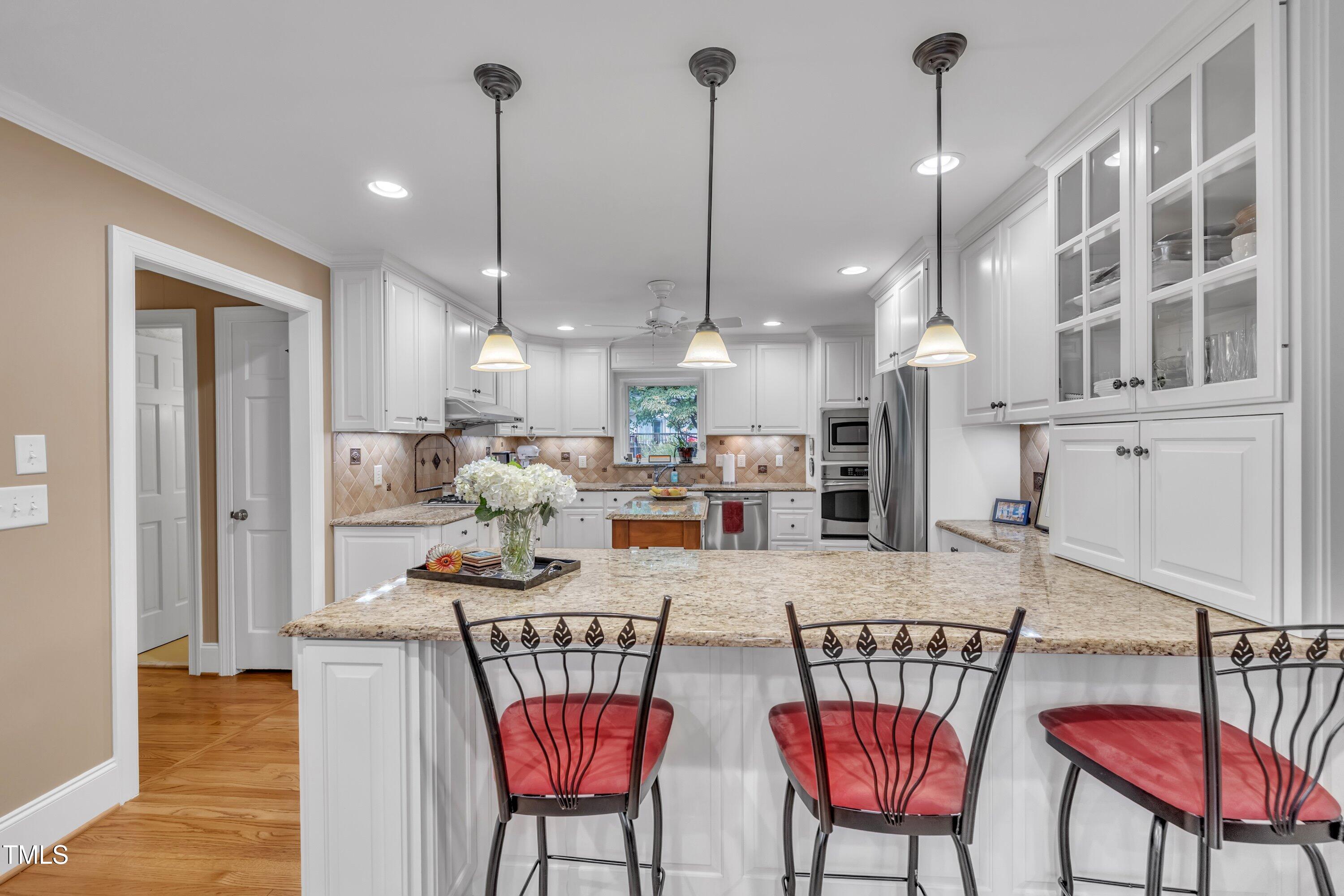 2013 Eagleton Circle Raleigh, NC 27609 - Photo 22 of 62 a view of a dining room and livingroom with furniture wooden floor a chandelier