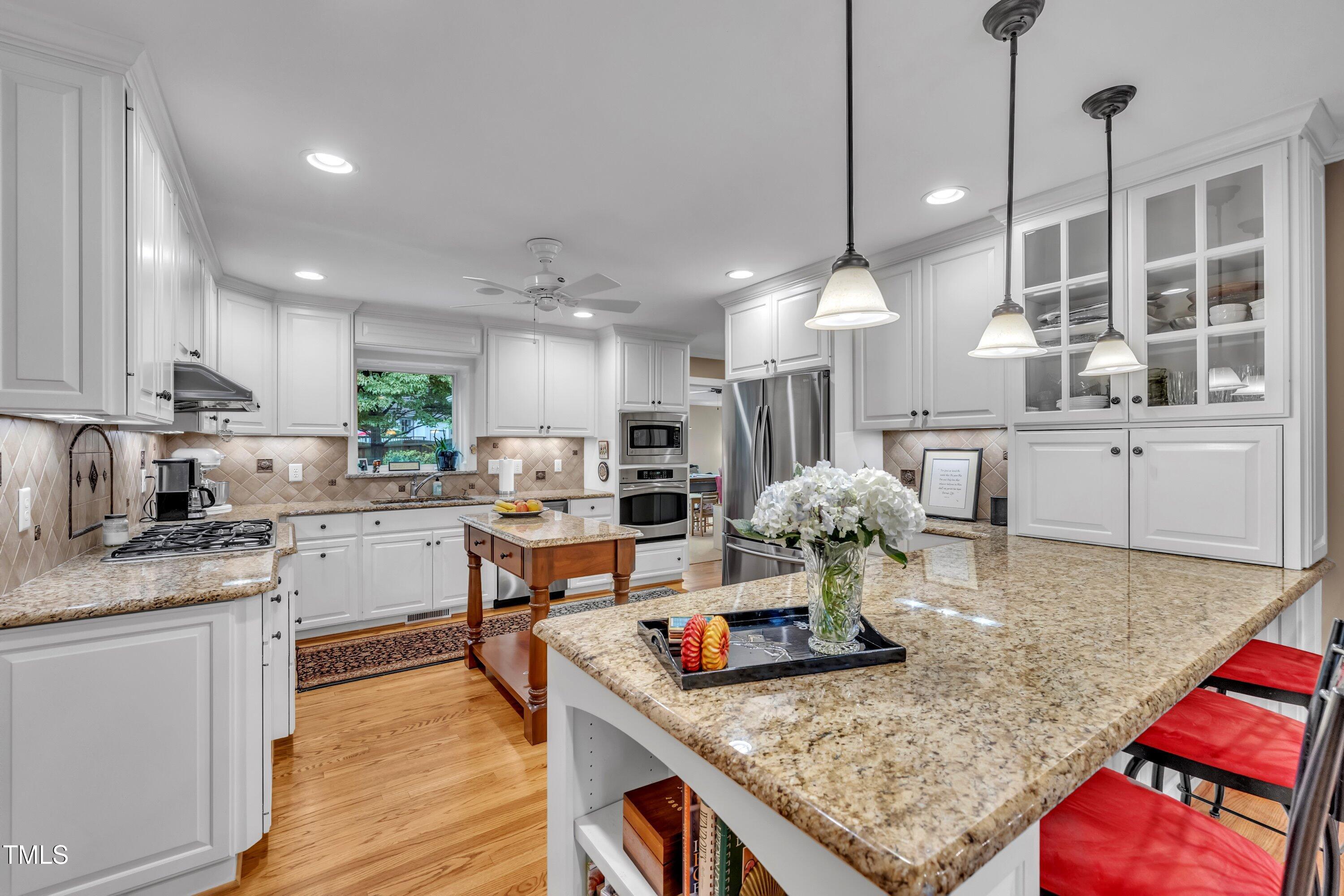 2013 Eagleton Circle Raleigh, NC 27609 - Photo 23 of 62 a kitchen with stainless steel appliances granite countertop a stove refrigerator and cabinets