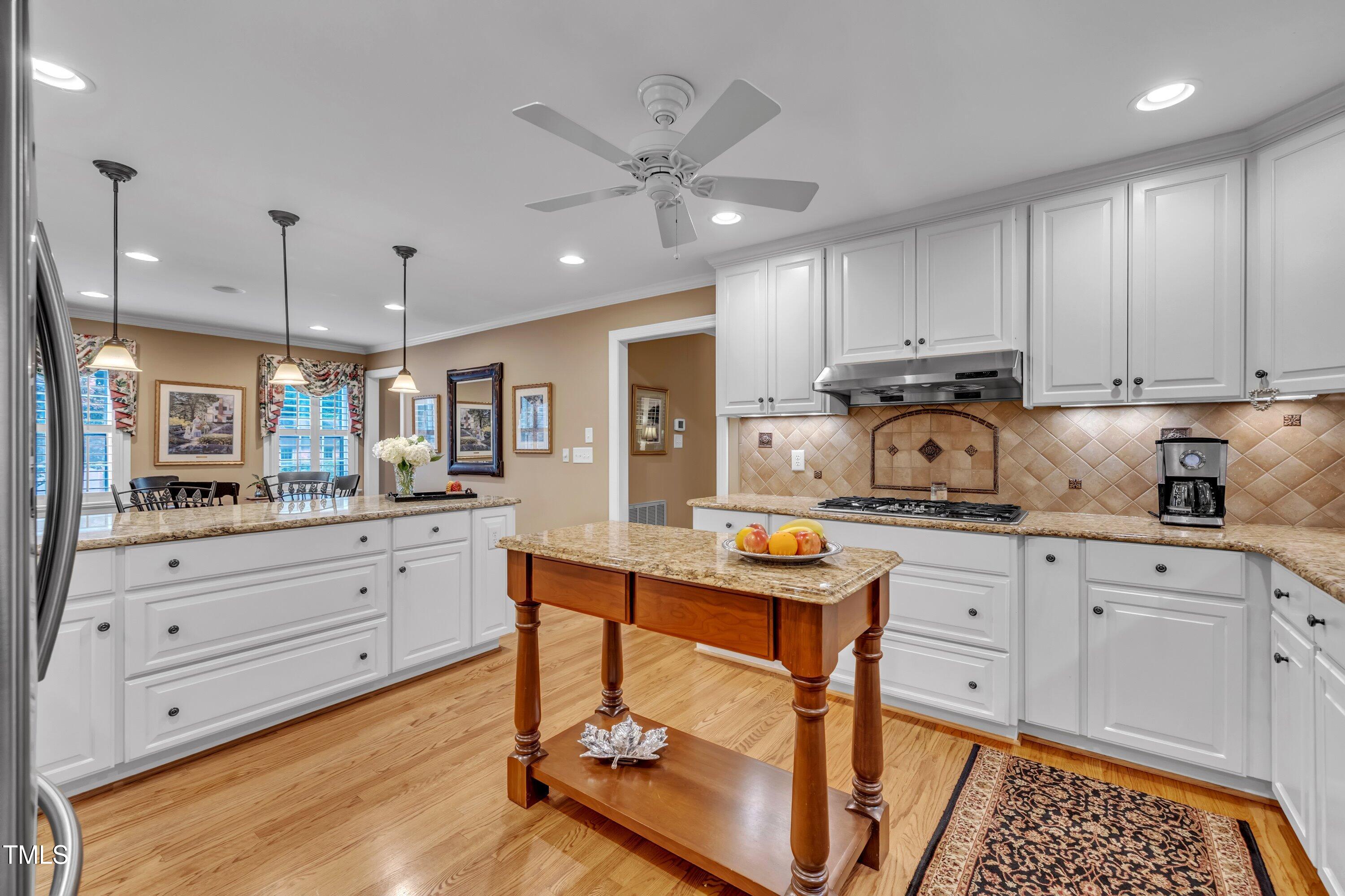 2013 Eagleton Circle Raleigh, NC 27609 - Photo 26 of 62 a kitchen with granite countertop white cabinets stainless steel appliances and sink