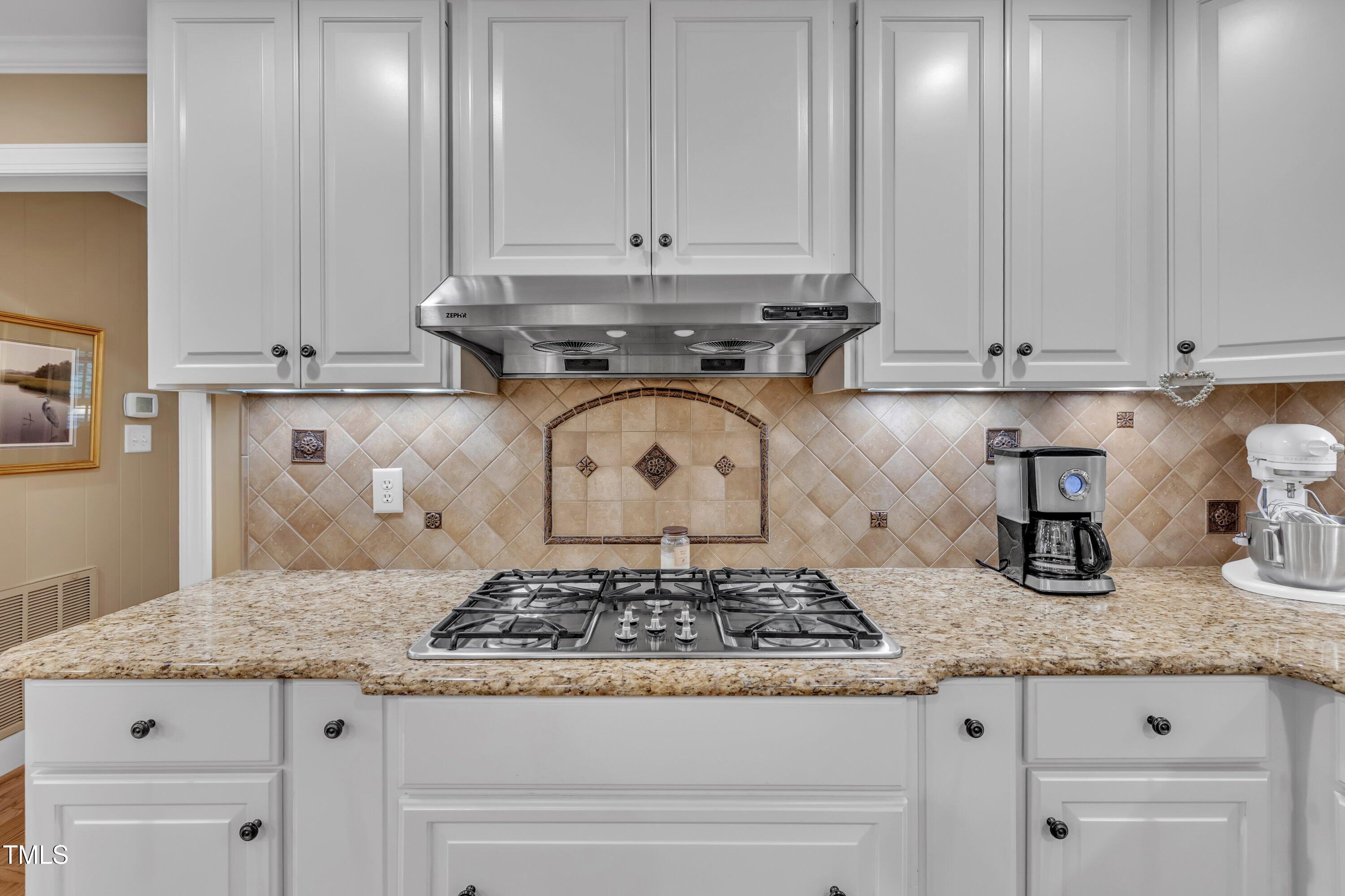 2013 Eagleton Circle Raleigh, NC 27609 - Photo 28 of 62 a kitchen with granite countertop white cabinets and a stove