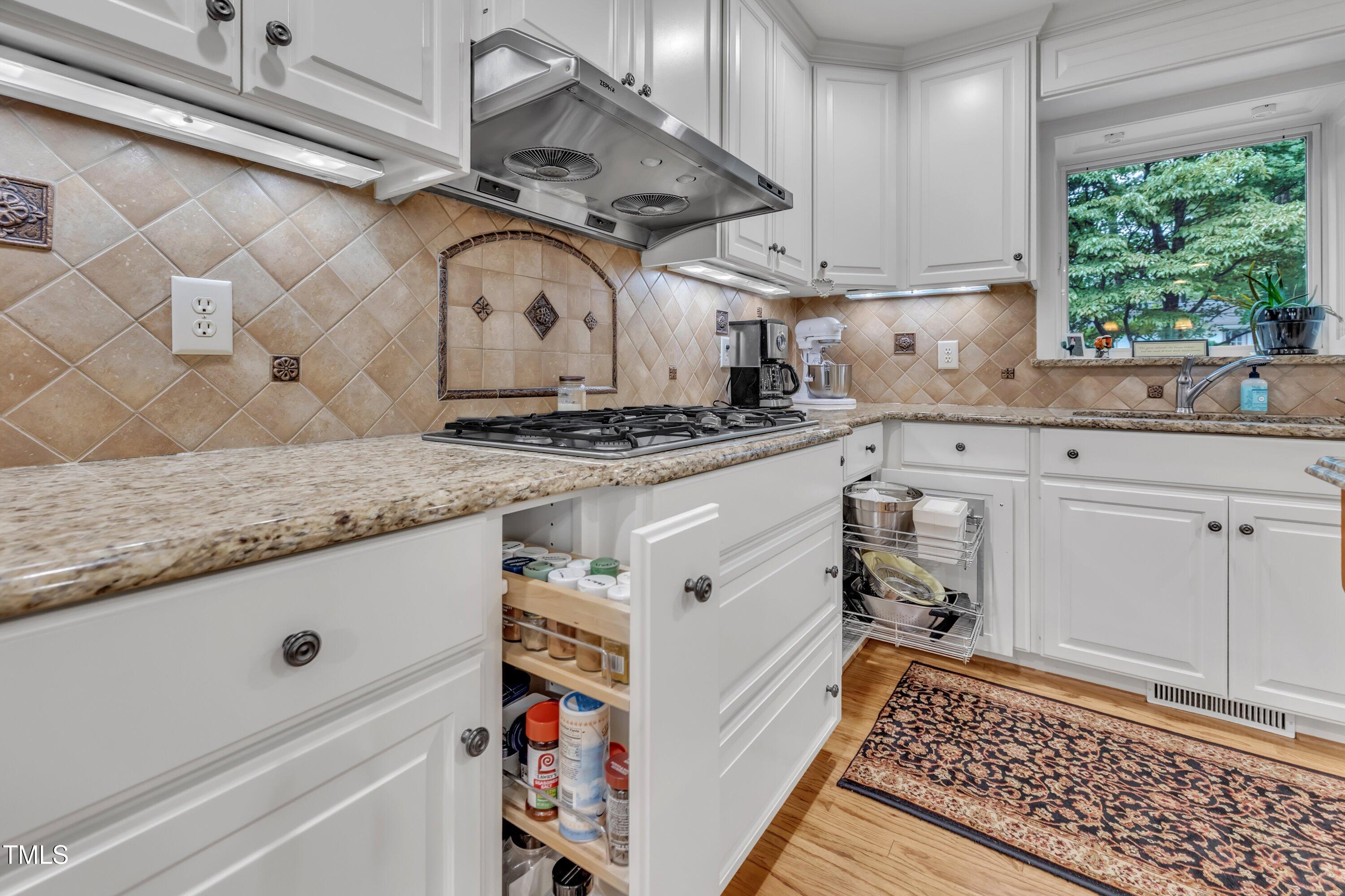 2013 Eagleton Circle Raleigh, NC 27609 - Photo 29 of 62 a kitchen with granite countertop cabinets a sink a window and stainless steel appliances