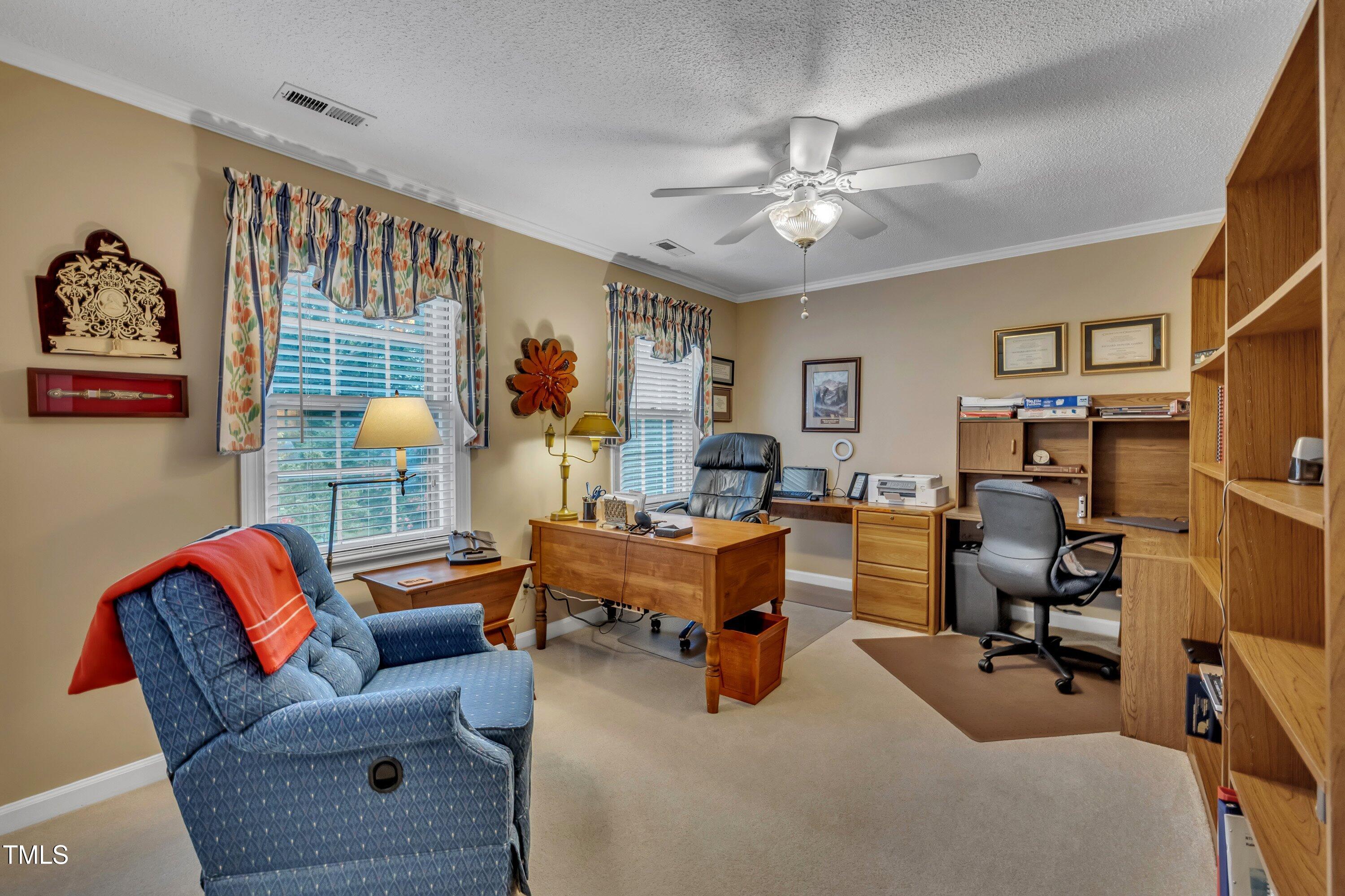 2013 Eagleton Circle Raleigh, NC 27609 - Photo 40 of 62 a view of a livingroom with workspace and a window