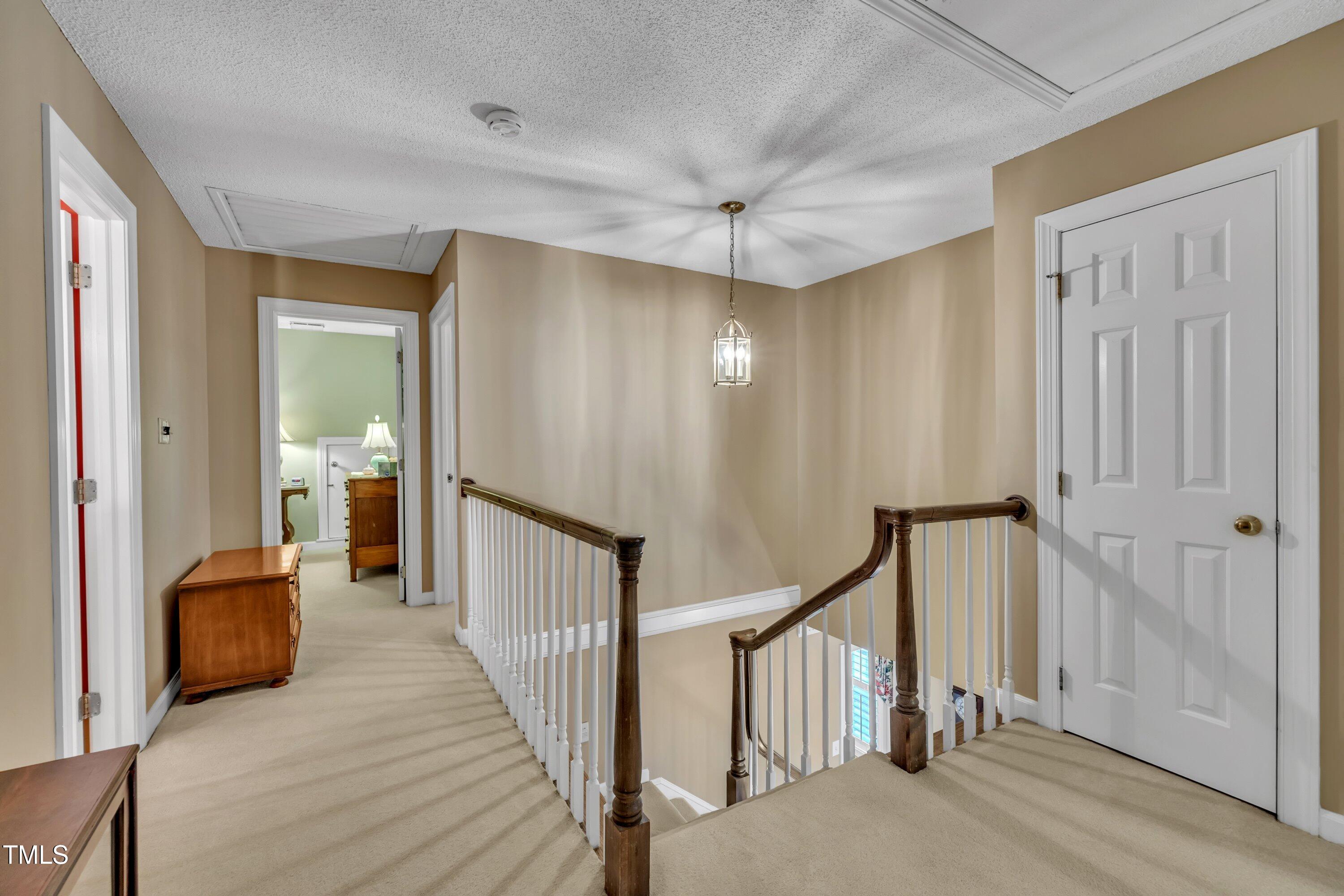 2013 Eagleton Circle Raleigh, NC 27609 - Photo 42 of 62 a view of a hallway with a livingroom and stairs