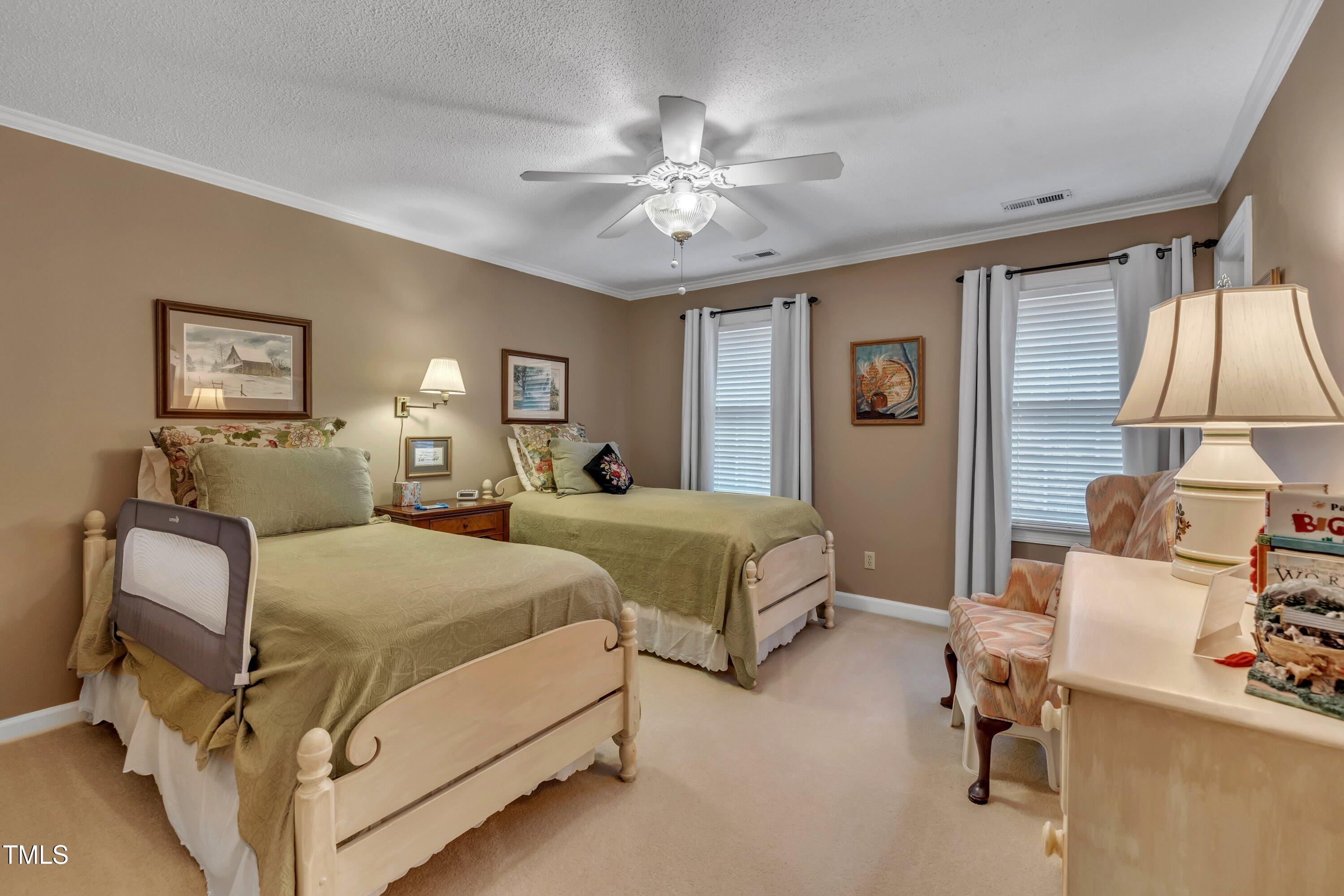 2013 Eagleton Circle Raleigh, NC 27609 - Photo 48 of 62 a bedroom with a bed and a chandelier
