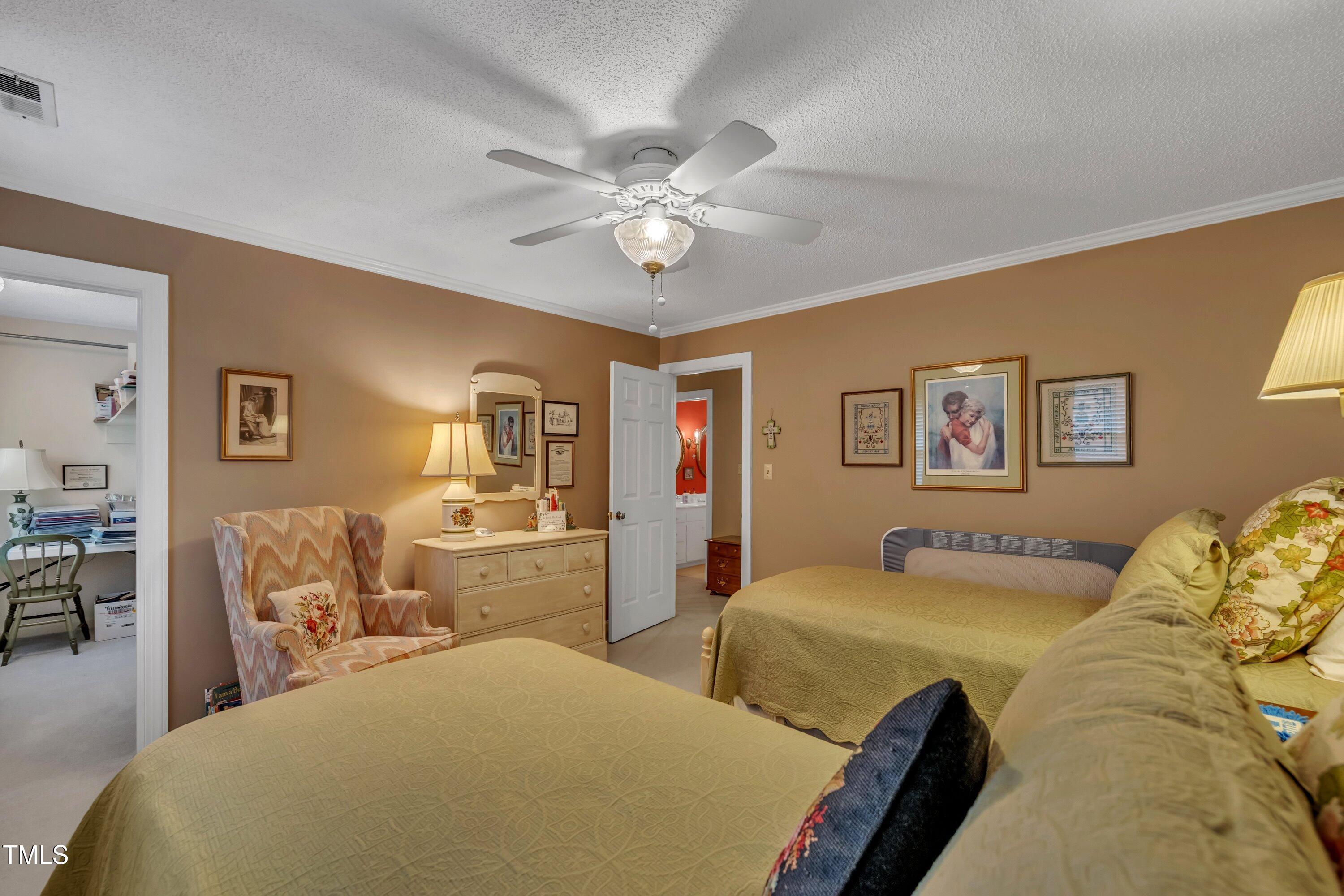 2013 Eagleton Circle Raleigh, NC 27609 - Photo 49 of 62 a bedroom with a large bed and a chandelier