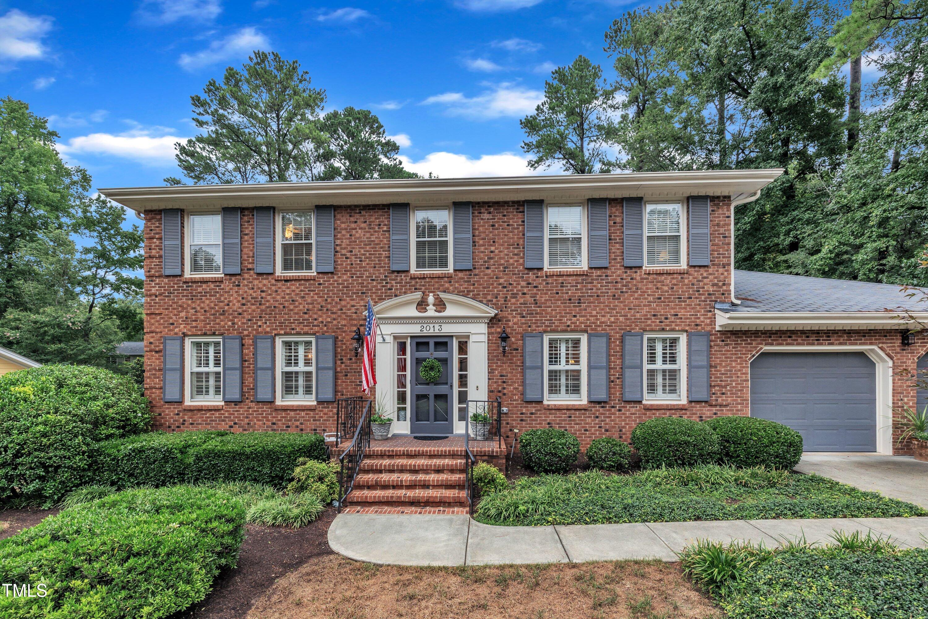 2013 Eagleton Circle Raleigh, NC 27609 - Photo 5 of 62 a front view of a house with a garden