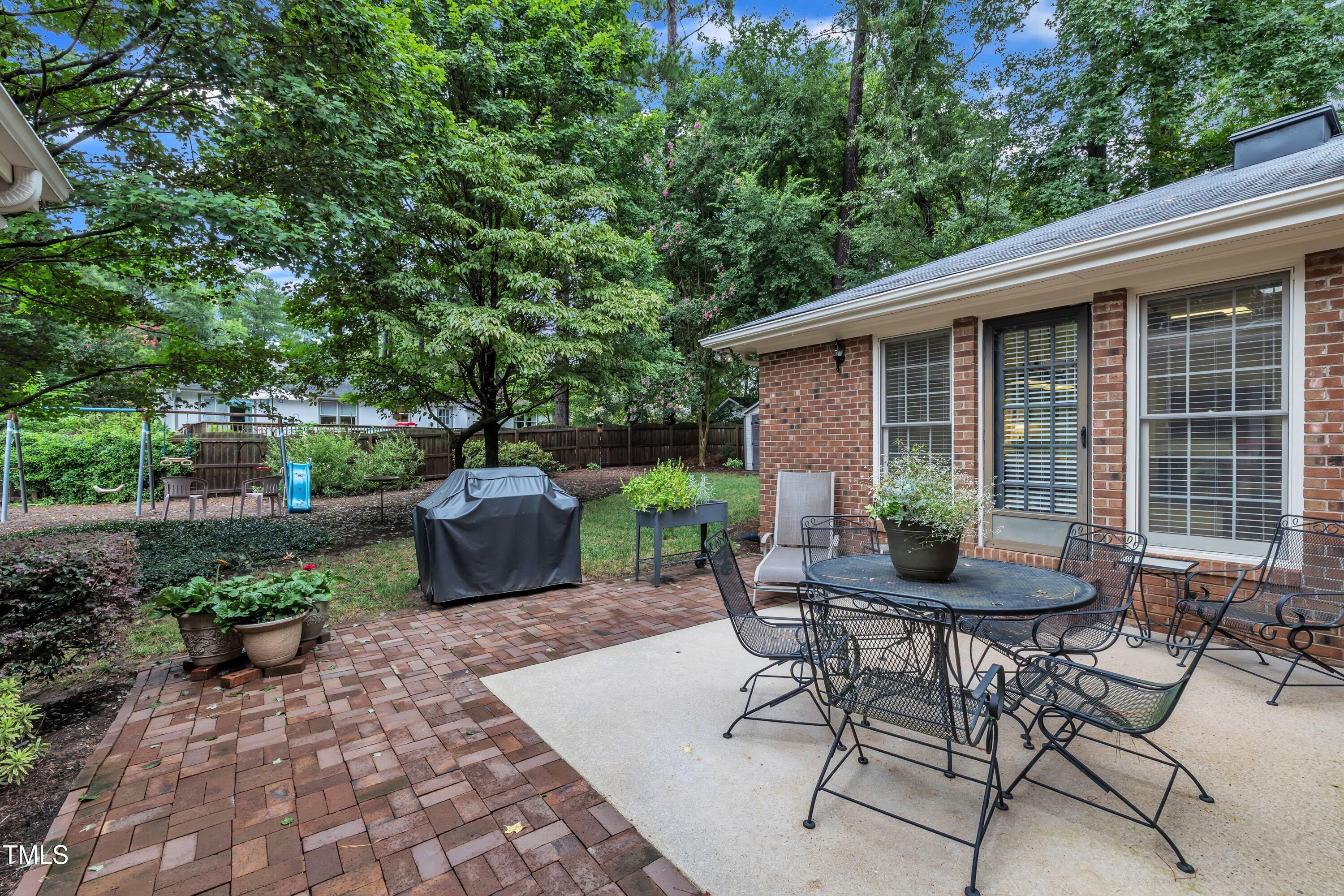 2013 Eagleton Circle Raleigh, NC 27609 - Photo 54 of 62 a view of a table and chairs in back yard of a house