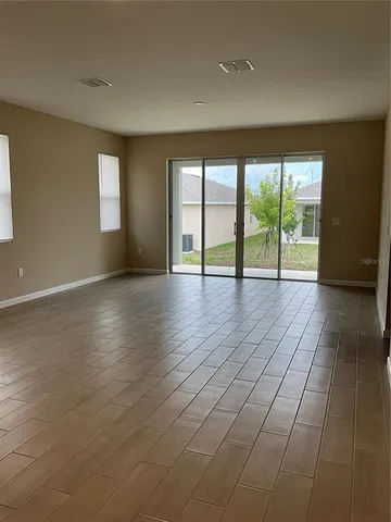a view of an empty room with glass door