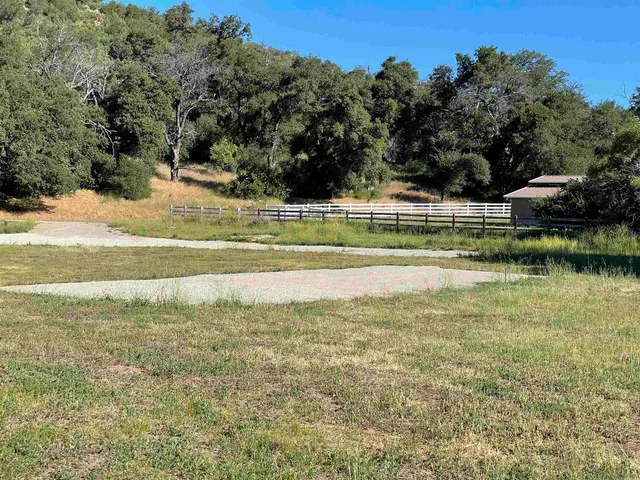 a view of a field with an ocean
