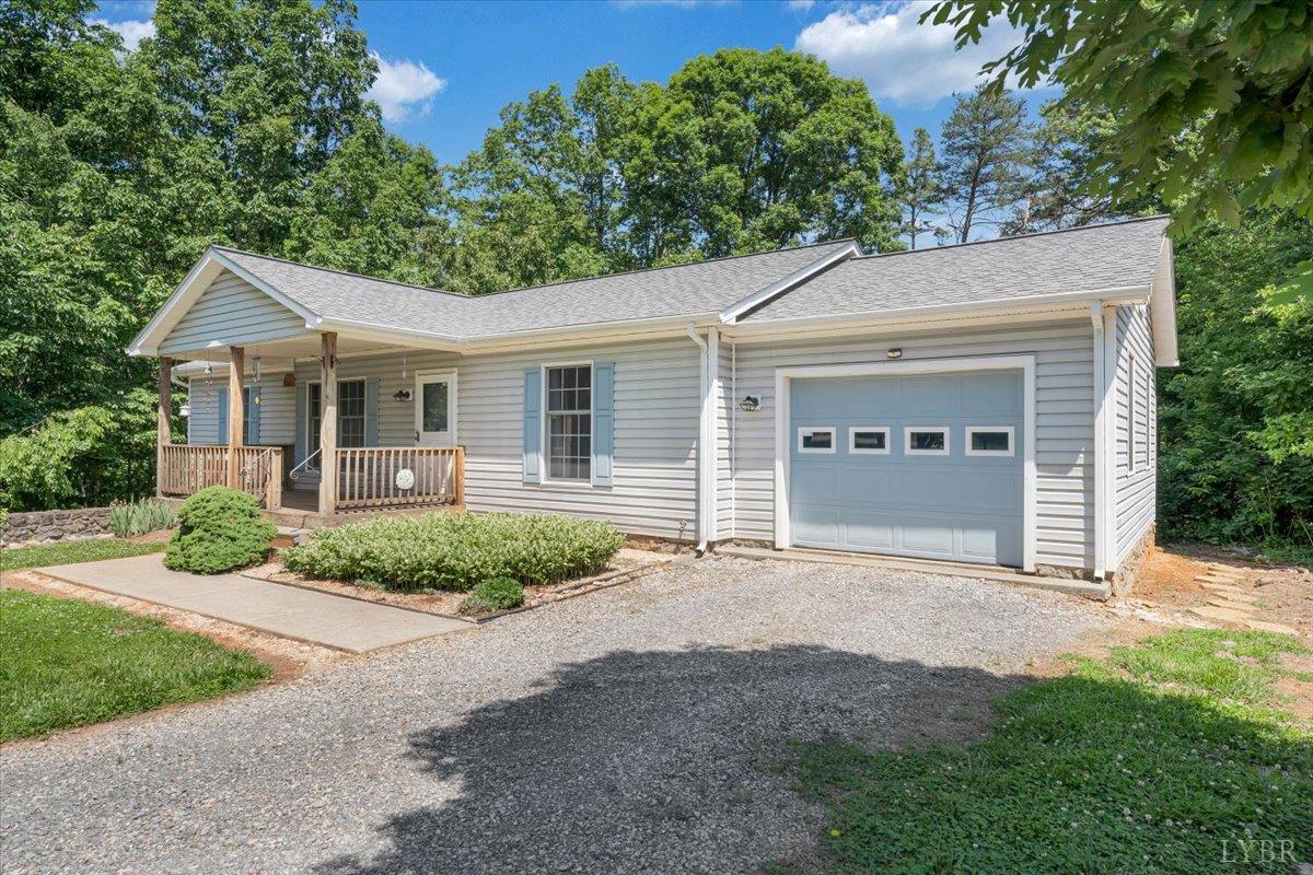 1124 Homeplace Road Bedford, VA 24523 - Photo 42 of 47 a front view of a house with a garden and garage