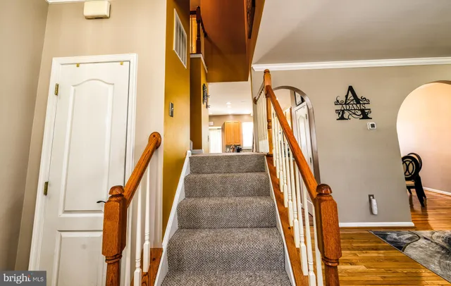 a view of a staircase and wooden door