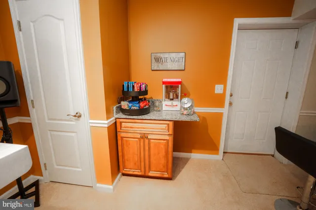 a living room with couches a rug and dining table