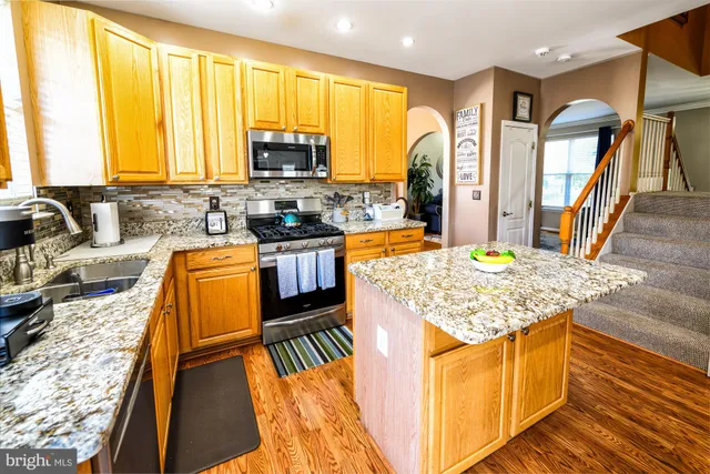 a living room with furniture a flat screen tv and a large window