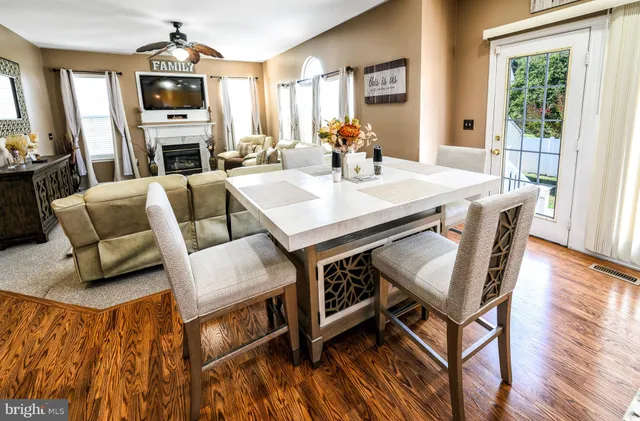 a room with table chairs and a flat screen tv