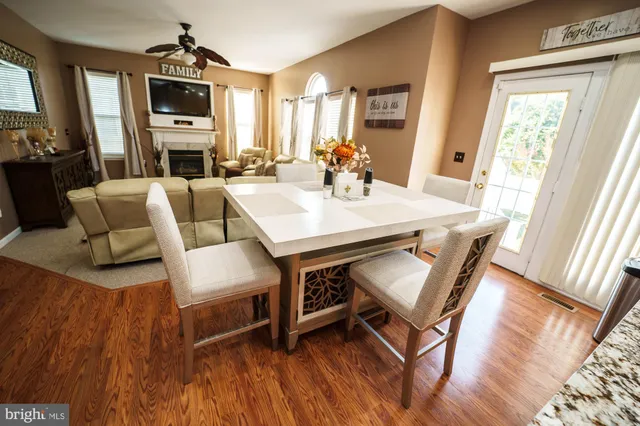 a view of a house with backyard and trees