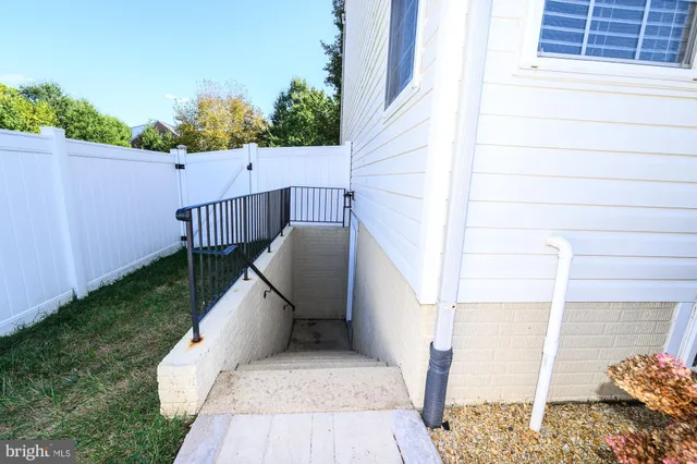 a living room with furniture a flat screen tv and kitchen view