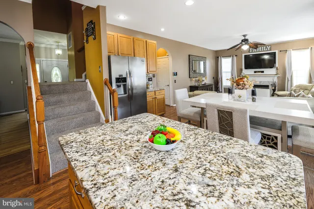 a large kitchen with kitchen island stainless steel appliances a sink stove and refrigerator