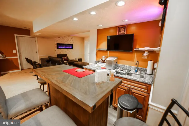 a outdoor dining space with furniture and a flat screen tv