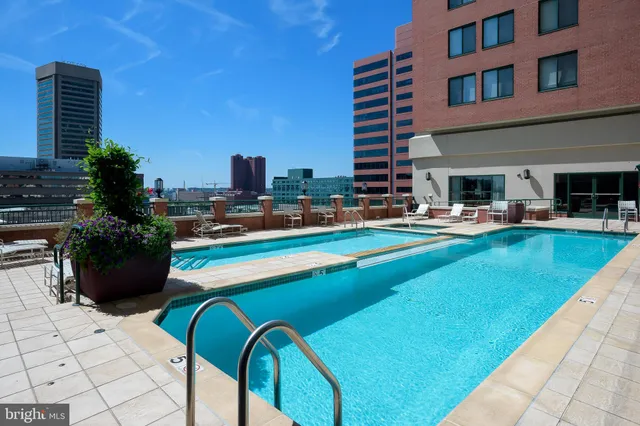 a backyard of a building with barbeque oven table and chairs