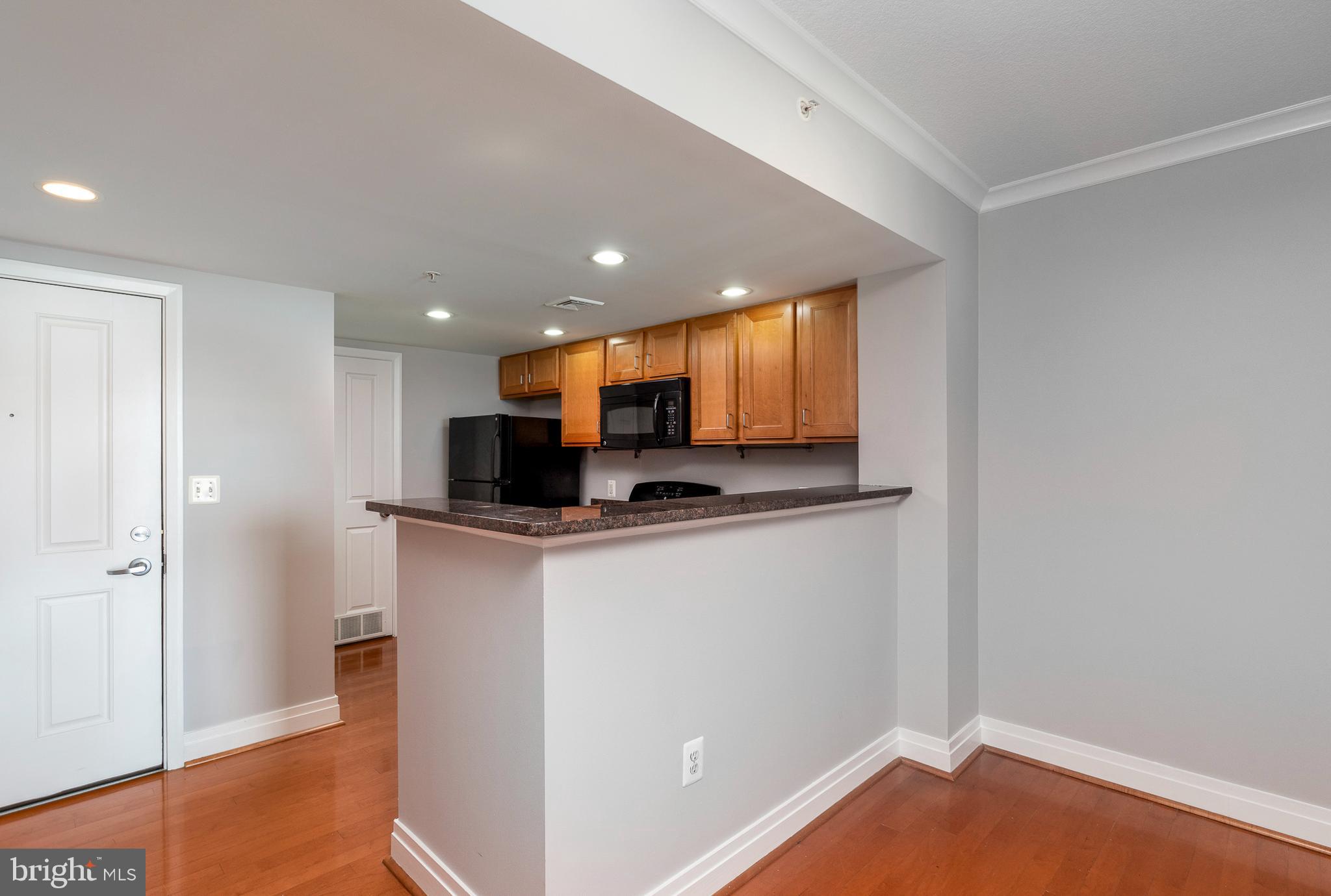 414 Water Street, Unit 2611 Baltimore, MD 21202 - Photo 6 of 23 a view of kitchen with stainless steel appliances granite countertop cabinets and a refrigerator