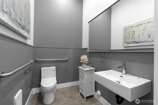 a bathroom with a toilet sink and mirror