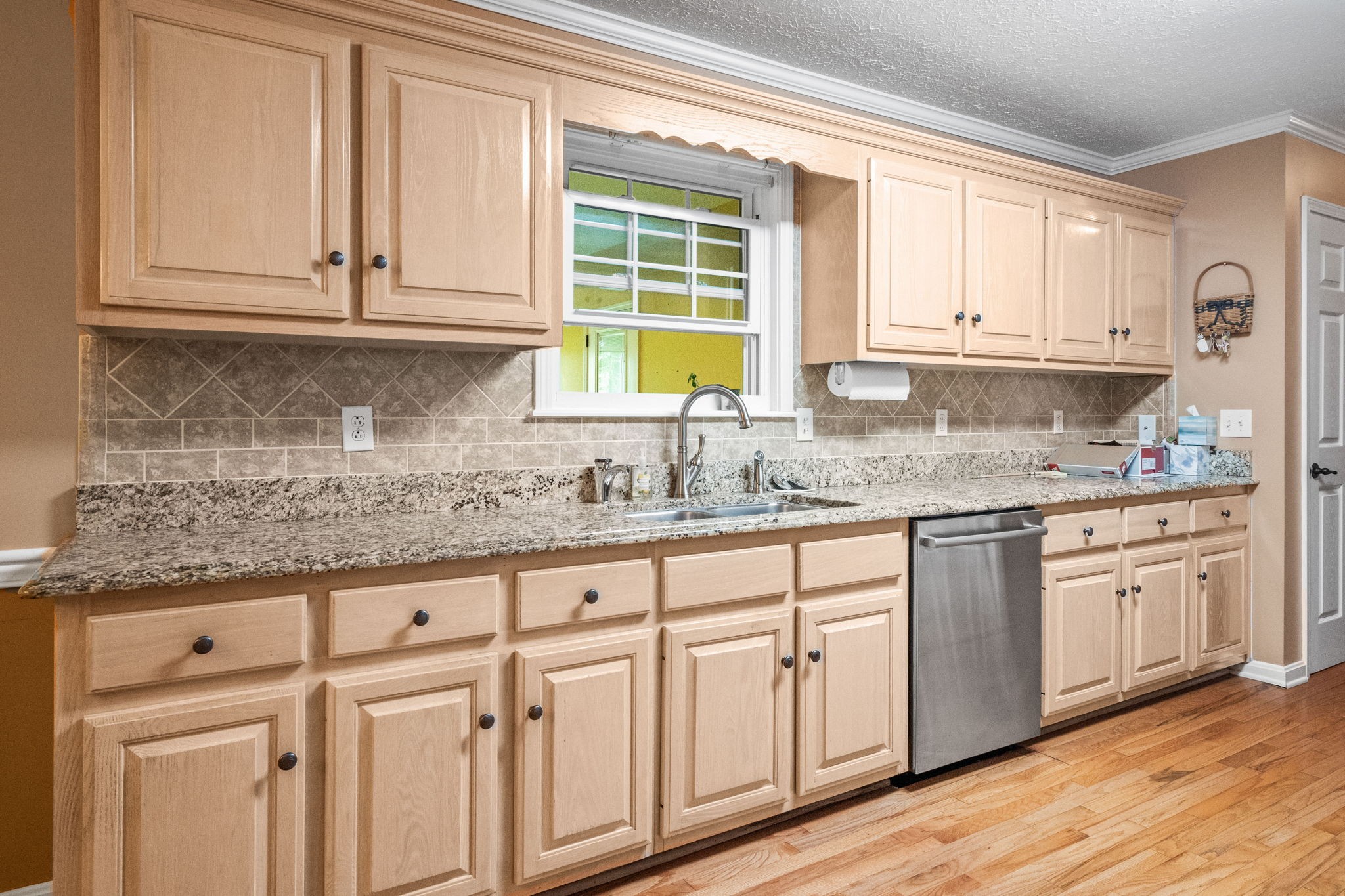 121 Biggs Road Cottontown, TN 37048 - Photo 5 of 12 a kitchen with granite countertop stainless steel appliances white cabinets and a window