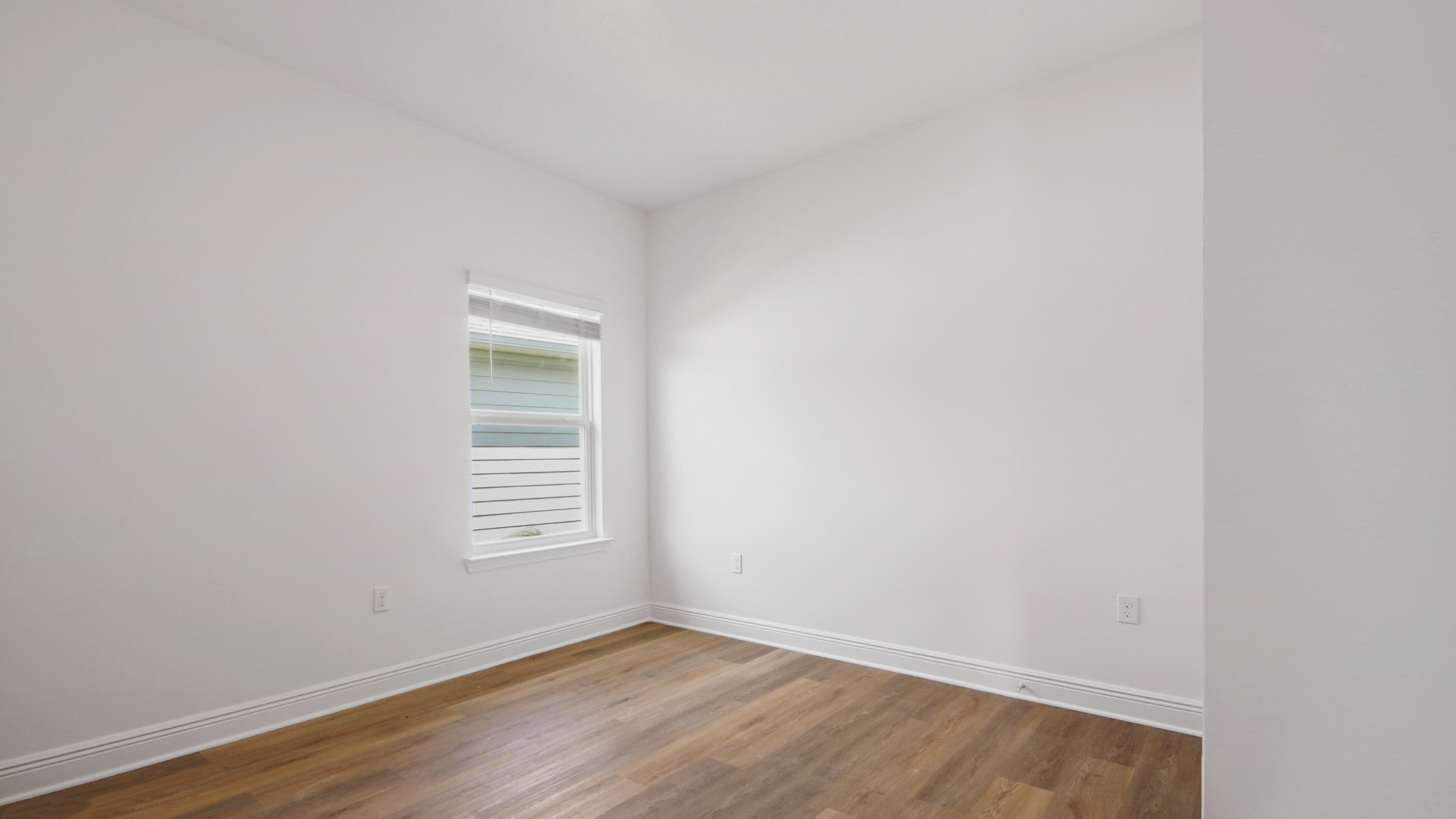 71 Gray Owl Drive Freeport, FL 32439 - Photo 11 of 33 a view of an empty room with wooden floor and a window