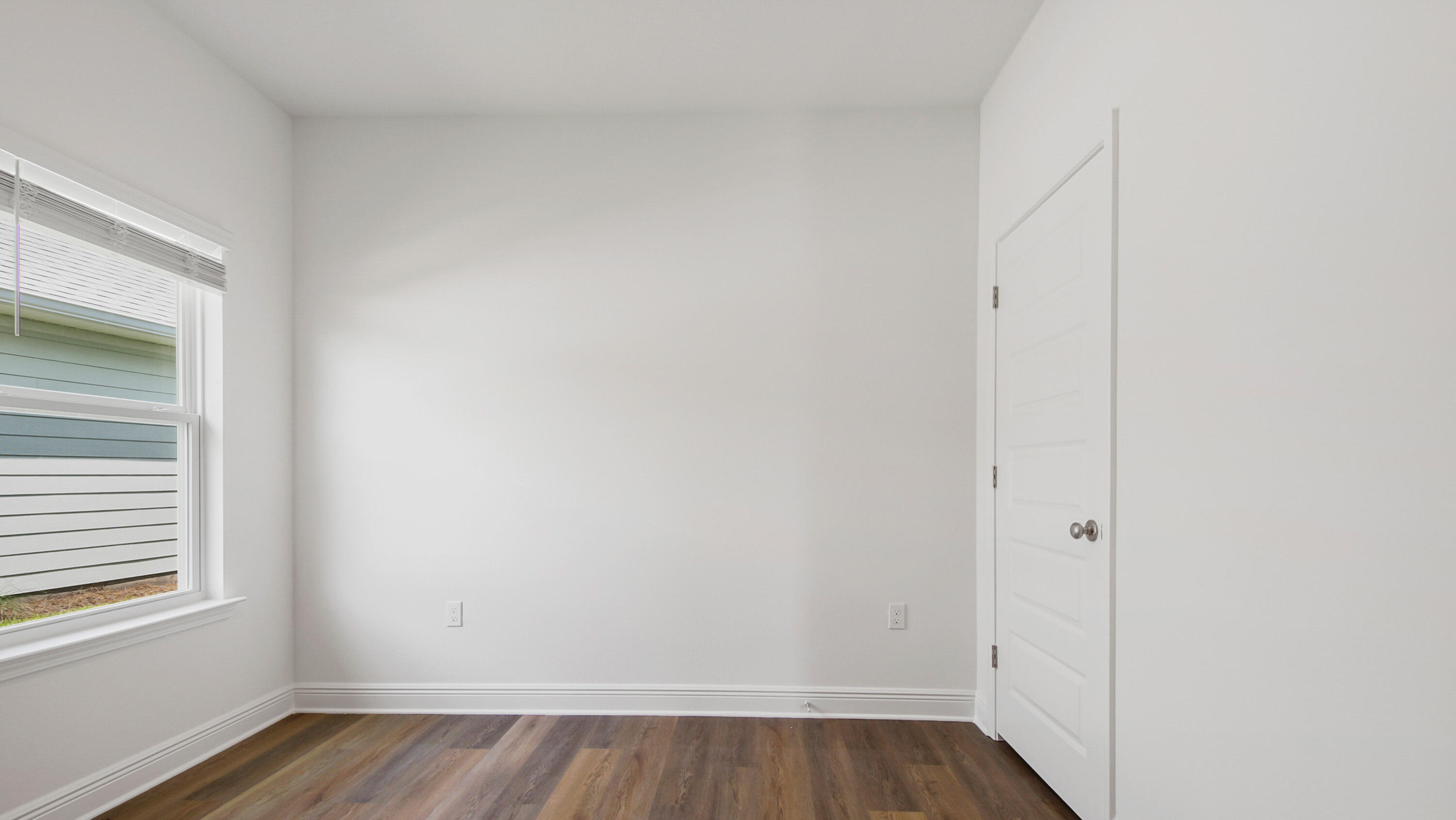 71 Gray Owl Drive Freeport, FL 32439 - Photo 12 of 33 a view of an empty room with wooden floor and a window