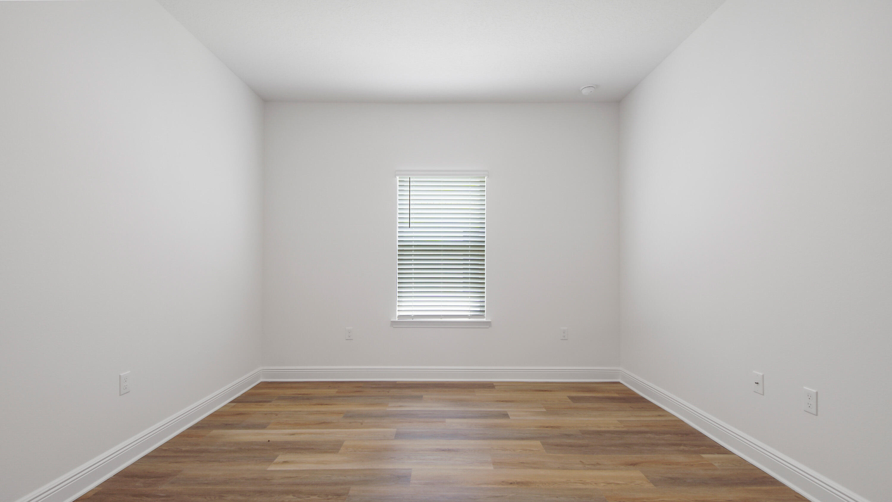 71 Gray Owl Drive Freeport, FL 32439 - Photo 14 of 33 a view of an empty room with wooden floor and a window