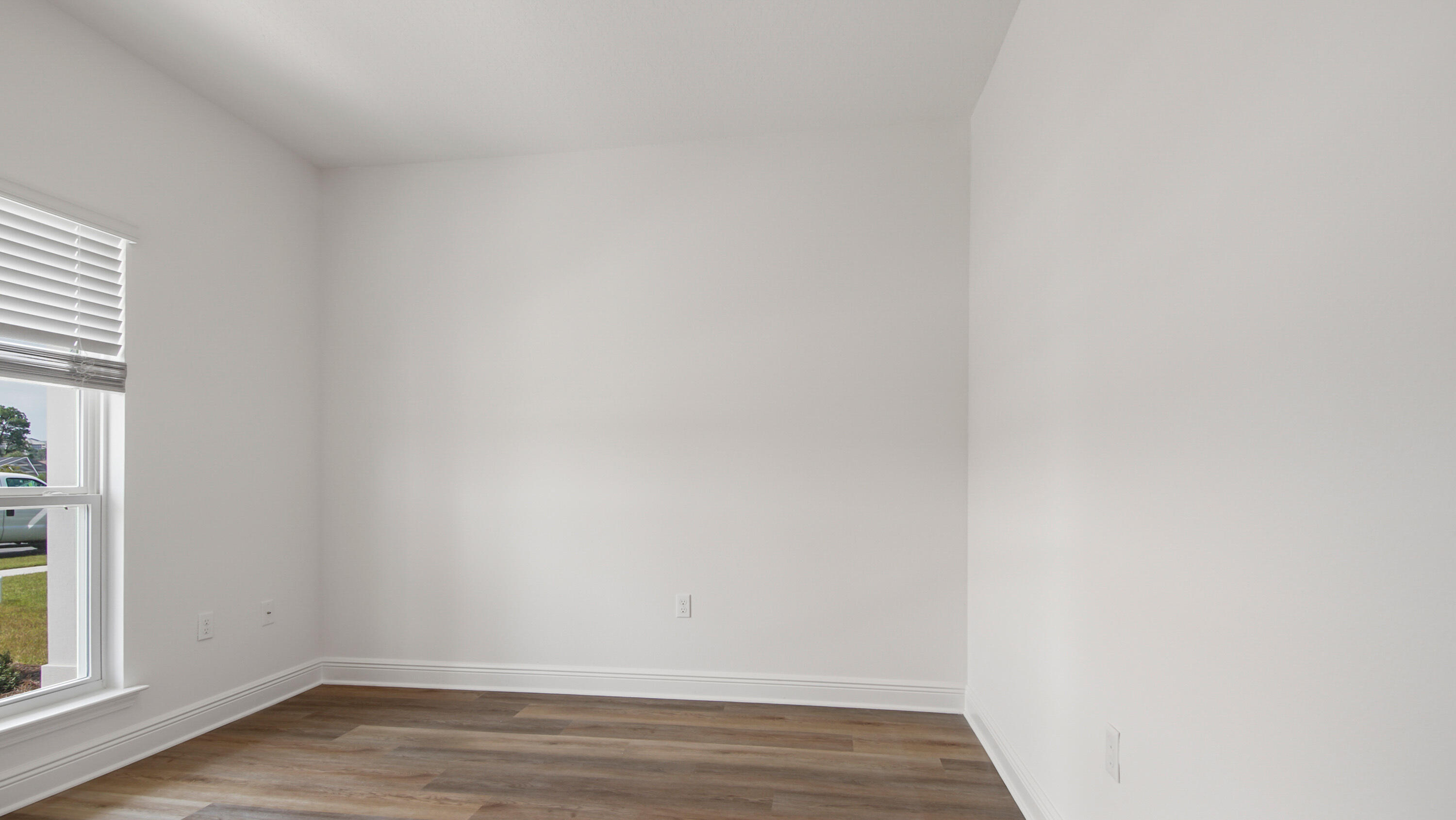 71 Gray Owl Drive Freeport, FL 32439 - Photo 7 of 33 a view of an empty room with wooden floor and a window