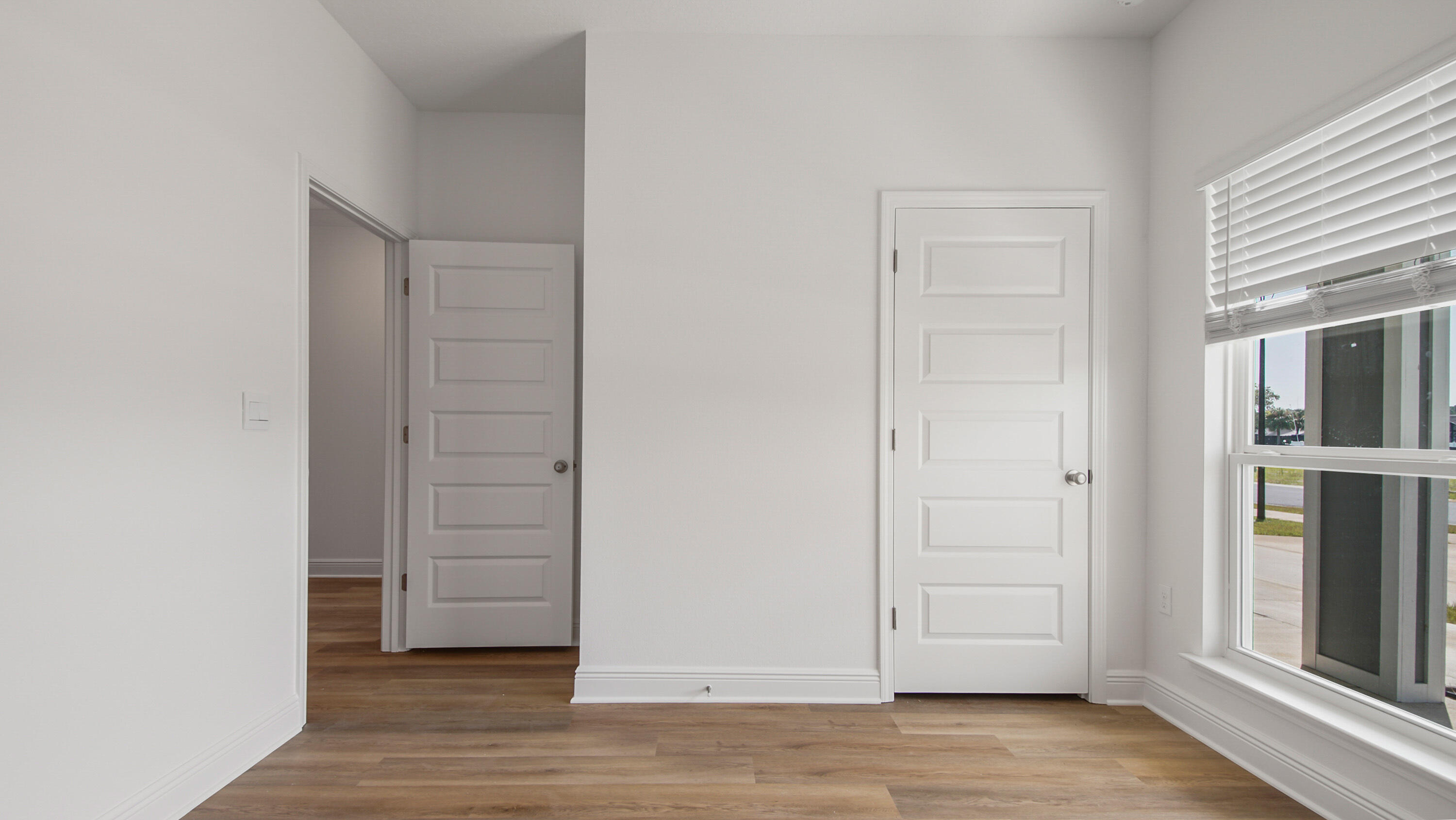 71 Gray Owl Drive Freeport, FL 32439 - Photo 8 of 33 an empty room with wooden floor closet and windows