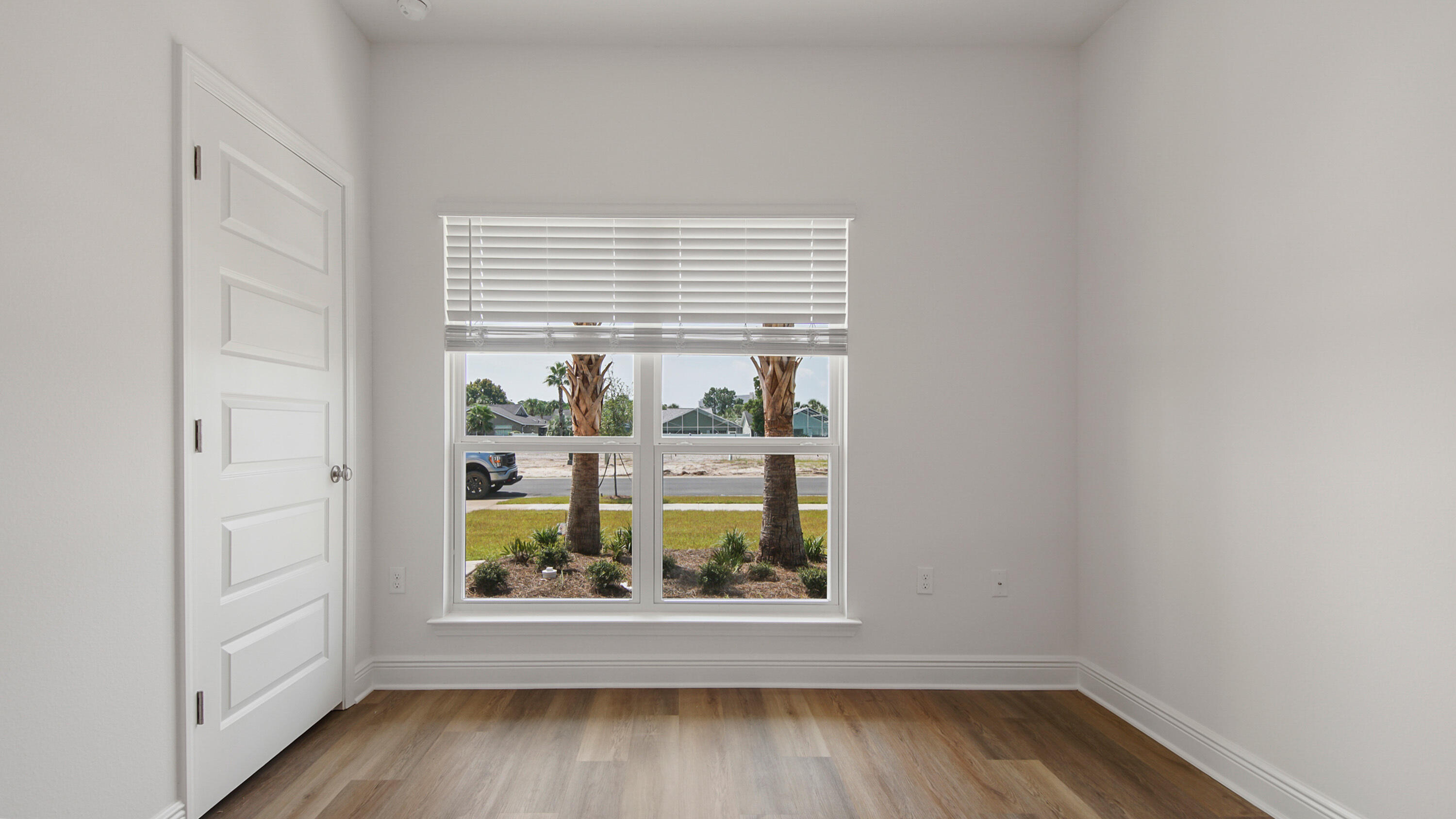 71 Gray Owl Drive Freeport, FL 32439 - Photo 10 of 33 an empty room with wooden floor and windows