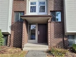 a view of a house with a door and wooden floor