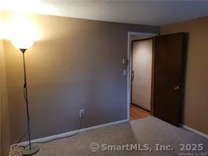 a view of a room with a wooden door