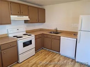 a kitchen with a sink stove and refrigerator