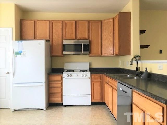 4905 Midstone Lane Raleigh, NC 27610 - Photo 2 of 22 a kitchen with a refrigerator stove and microwave