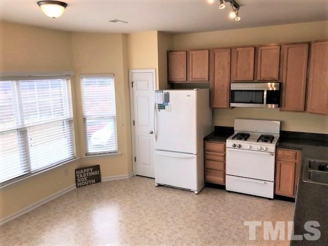 4905 Midstone Lane Raleigh, NC 27610 - Photo 3 of 22 a kitchen with a stove and a refrigerator