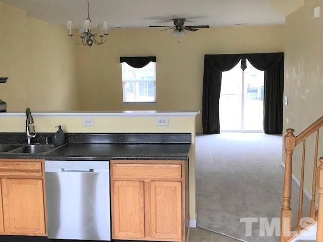 4905 Midstone Lane Raleigh, NC 27610 - Photo 5 of 22 a kitchen with a sink and a refrigerator