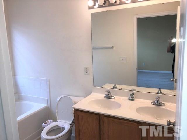 4905 Midstone Lane Raleigh, NC 27610 - Photo 9 of 22 a bathroom with a sink toilet and tub