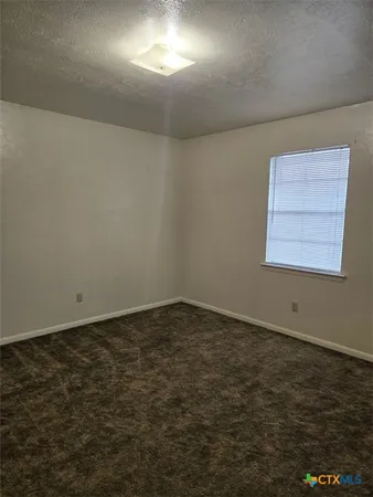 an empty room with a empty space and window