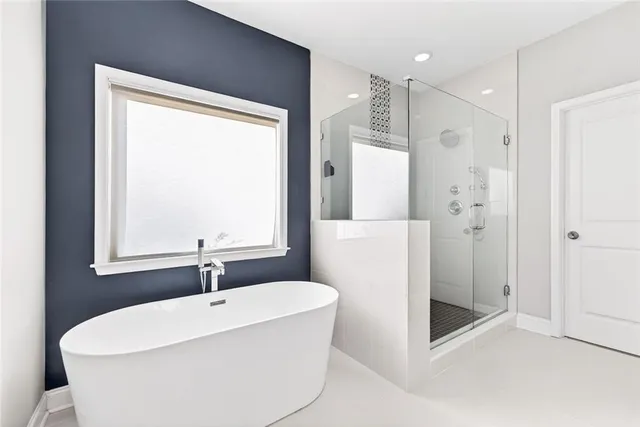a white bath tub sitting next to a white sink