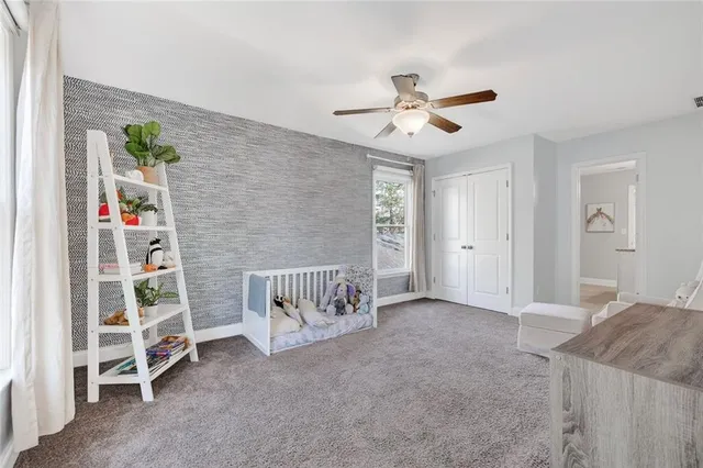 a bedroom with bed a chandelier and a window